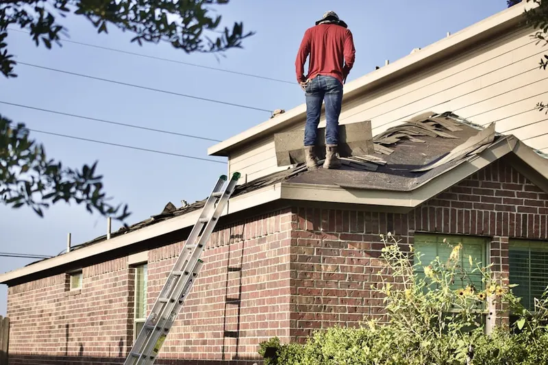 Professional roofer working on a residential roof in Midway City